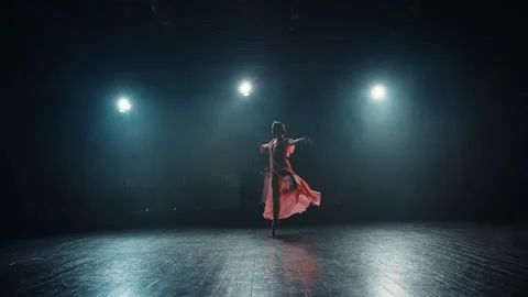 Silhouette of young ballet dancer in pointe shoes and flowing dress. Graceful Stock Footage 256590211