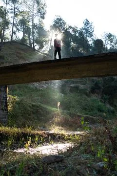 Silhouette of a young boy while sun rays coming from behind Stock Photos
