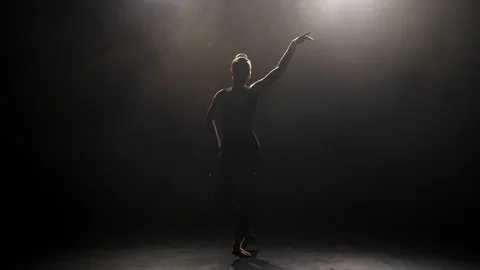 Silhouette of young dancer in darkness of studio Video stock 123805427