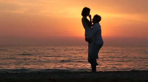 Silhouette - Young Family On Beach Stock Footage