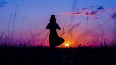 Silhouette of a Young Girl Practicing Yoga Tree Pose At  Sunset 스톡 동영상 59541353