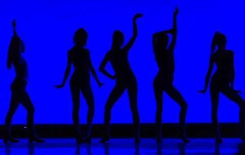 Silhouette of young girls dancing with blue/black creative approach Stock Photos