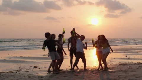 Silhouette of Young group dancing and drinking on the beach summer and sunset. Stock Footage 184283388