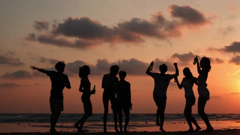 Silhouette of Young group dancing and drinking on the beach summer and sunset. Stock Footage 184284779