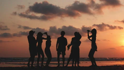 Silhouette of Young group dancing and drinking on the beach summer and sunset. Stock Footage 184285451