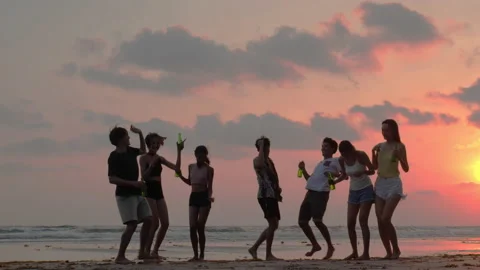Silhouette of Young group dancing and drinking on the beach summer and sunset. Stock Footage 184301605