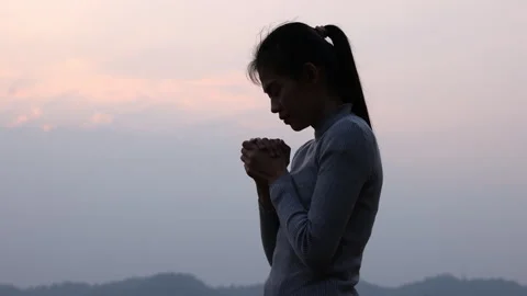 Silhouette of young human hands praying to god at sunrise, Christian Religi.. Stock Footage 336943361