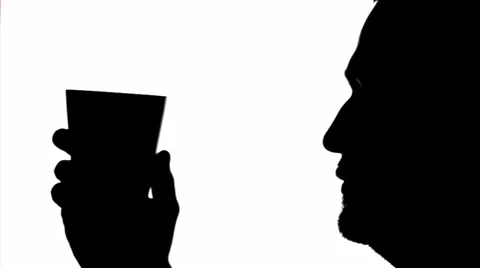 Silhouette young man is drinking with a cup. Stock Footage 36942746