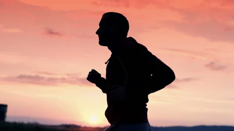 Silhouette of young man jogging during sunset super slow motion, 240Fps HD Stock Footage 40103348