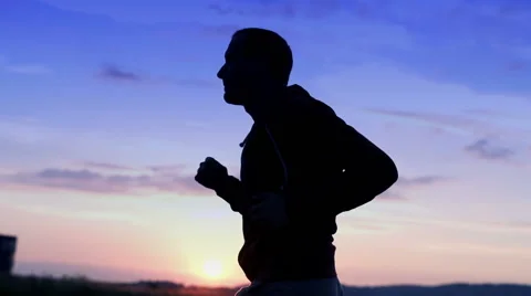 Silhouette of young man jogging during sunset HD Stock Footage 40103475