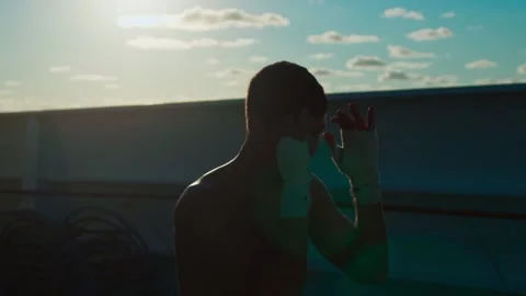 Silhouette of young man practice shadow boxing outdoors onboard cruise ship Stock-Footage 196203243