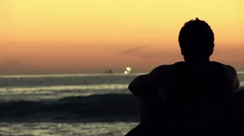 Silhouette of Young Man Staring at Ocean, Rack Focus Stock Footage 7731487