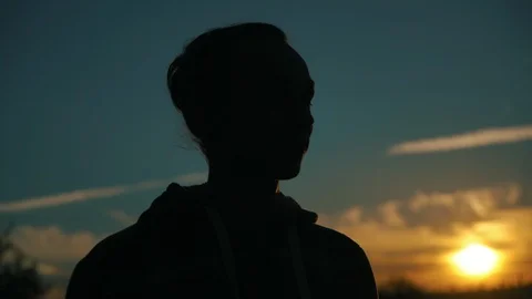 Silhouette of young man on sunset background outdoors, 4k 動画素材 98213703