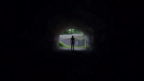 Silhouette of a young man in tunnel Stock Footage 255846183