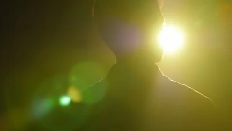 Silhouette of young man walking and looking around in the dark smoky room. Video stock 106471925
