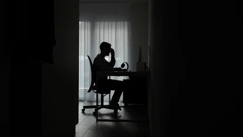Silhouette young man working on computer frustrated, tired and angry, rubs Stock Footage 122040078