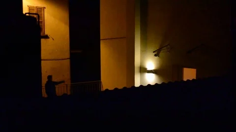 Silhouette of young rapper dancing hip-hop on a terrace in night hours. Stock Footage 107402664