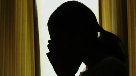 Silhouette of young woman with headache, indoors HD Stock Footage