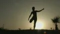 Silhouette of young woman stretching before doing exercises early in the morning HD Footage