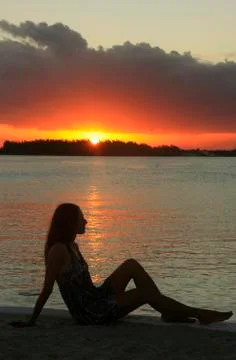 Silhouette of young woman at sunset, boca chica bay Stock Photos