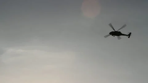 Silhouetted Blackhawk Helicopter Flyover Stock Footage 22322652