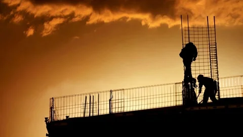 Silhouetted Construction Workers at Sunset Stock Footage 276292805