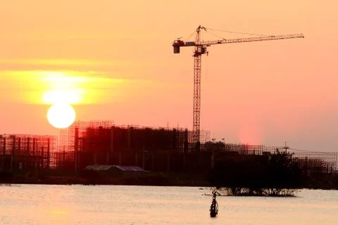 Silhouetted crane on sunset . Stock Photos