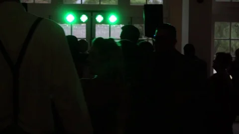Silhouetted crowd dances while camera moves through them Stock Footage 71252309