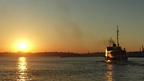 Silhouetted Crowd on a Ferry at Sunset with a Scenic View of Istanbul's Skyline Stock Footage 278732230