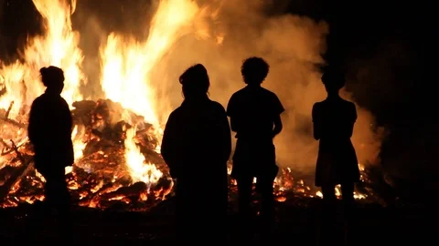 Silhouetted crowd by fire Stock Footage 122725556
