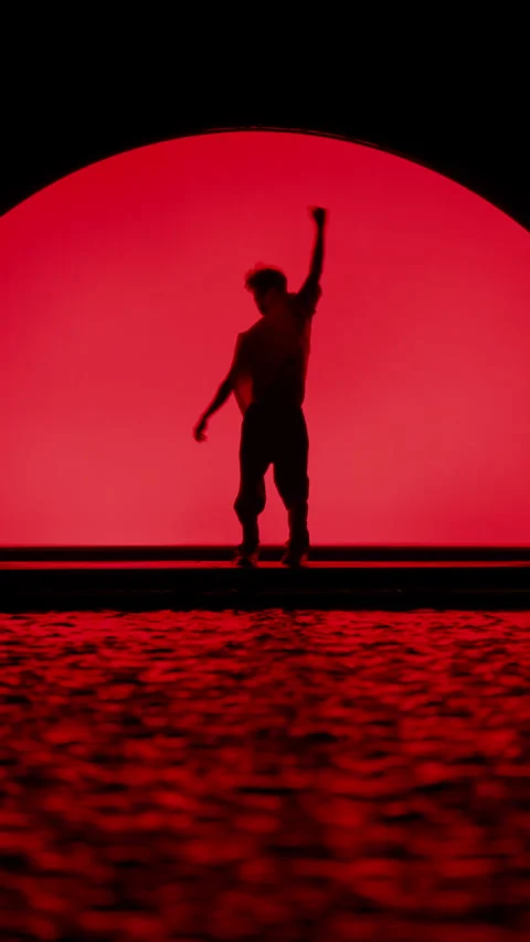 Silhouetted Dancer On Stage With Red Backlight Stock Footage 255538102