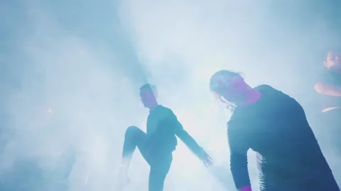 Silhouetted Dancers in Dramatic Stage Lighting Stock Footage 296596755