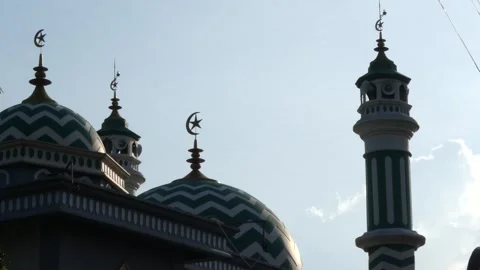 Silhouetted domes of a mosque with geometric patterns and crescent moon fin.. Stock Footage 345198273