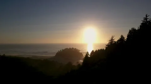 Silhouetted drone shot approaches Proposal rock, Neskowin beach at Sunset Stock Footage 249028188