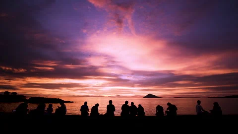 Silhouetted Figures At Sunset On A Beach Stock Footage 300582489