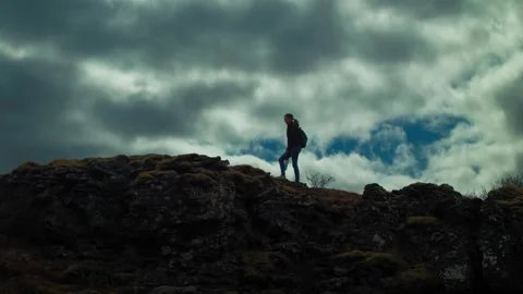 Silhouetted hiker against a dramatic sky 스톡 동영상 274511041