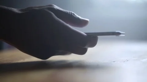 Silhouetted Male Hands Browsing Through Smartphone Stock Footage 78188305