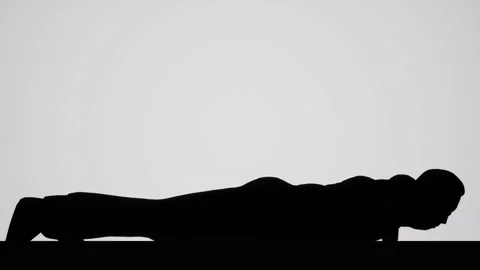 A Silhouetted man doing push ups Stock Footage 155224242