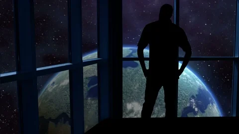 Silhouetted man overlooking the Earth from space. Stock Footage 112874613