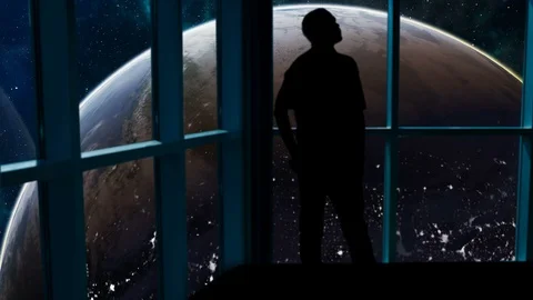 Silhouetted man overlooking the Earth from space. Stock Footage 112876011