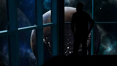 Silhouetted man overlooking the Earth from space. Stock Footage 112878369