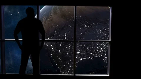 Silhouetted man overlooking the Earth from space Stock Footage 112887428