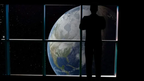 Silhouetted man overlooking the Earth from space. Stock Footage 112890685