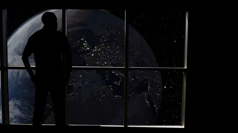 Silhouetted man overlooking the Earth from space. Stock Footage 112892450