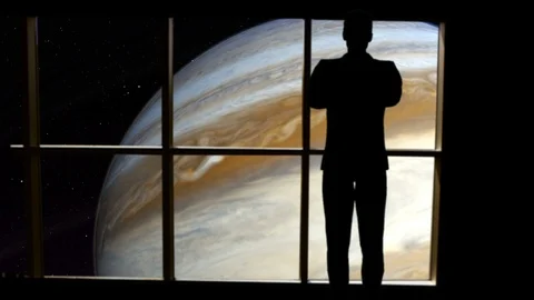Silhouetted man overlooking Jupiter from space. Stock Footage 112884159