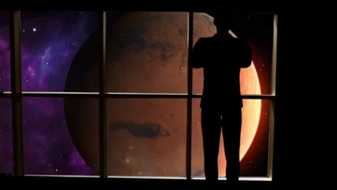 Silhouetted man overlooking Mars from space. Stock Footage 112890600
