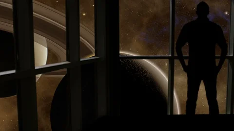 Silhouetted man overlooking Saturn and a moon from space. Stock Footage 112882541