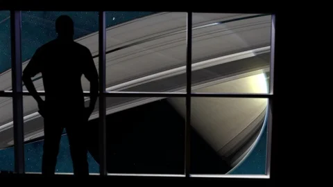 Silhouetted man overlooking Saturn from space. Stock Footage 112887326