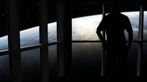 Silhouetted man overlooking the sunrise over Earth from space. Stock Footage 112876418