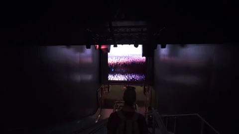 Silhouetted Man Walks Down Escalators in New York City, Gimbal Tilt Stock Footage 146554592